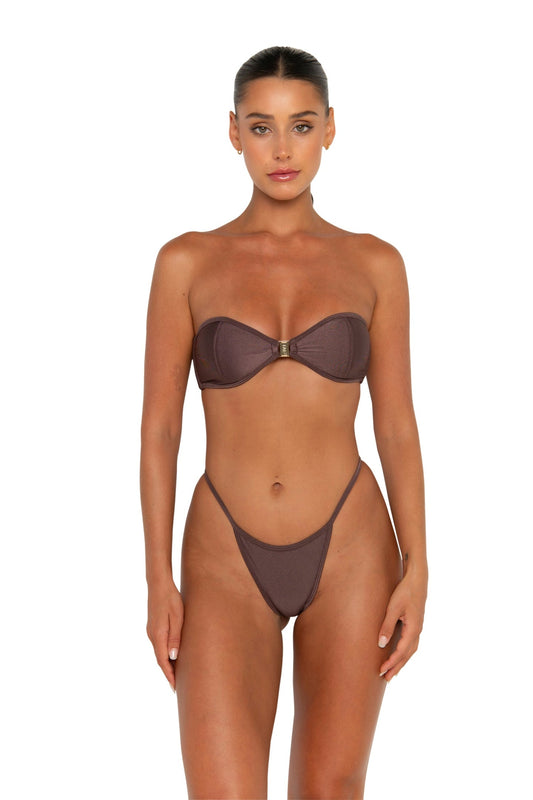 Woman wearing a brown bikini set on a white background